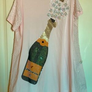 Queen of Sparkles Popping Champagne Tee dress in light pink. NWOT. Size Medium.